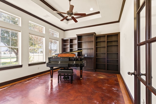 miscellaneous room with ceiling fan, ornamental molding, a wealth of natural light, and a tray ceiling