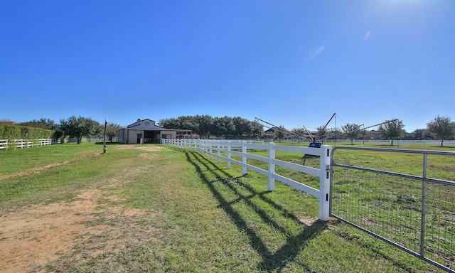 view of yard with a rural view and an outdoor structure