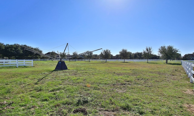 view of yard with a rural view