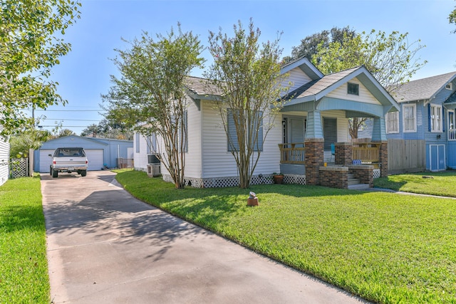 view of front of property with a front yard, a garage, and an outdoor structure