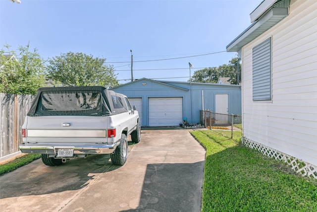 detached garage featuring fence