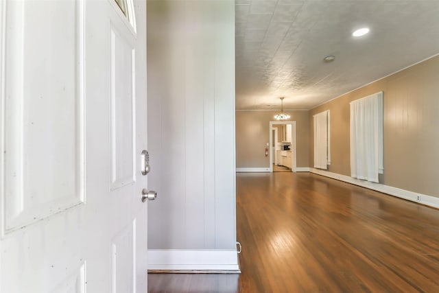foyer entrance with baseboards and wood finished floors