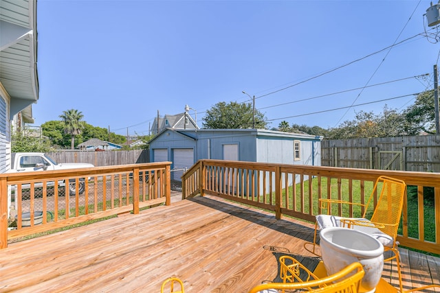 wooden terrace featuring an outdoor structure and a yard