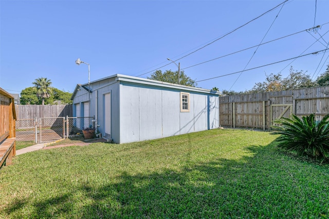 exterior space with a fenced backyard and a gate