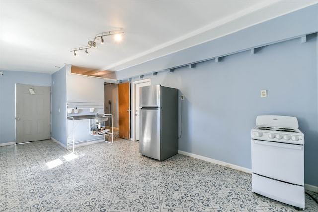 kitchen with white stove and stainless steel fridge