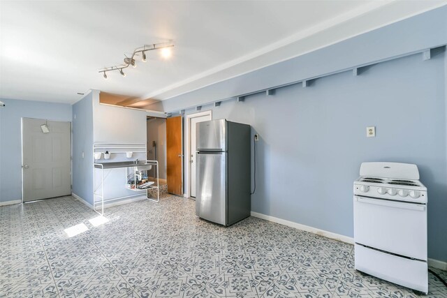 kitchen with freestanding refrigerator, baseboards, and white electric range oven