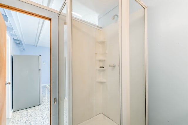 bathroom featuring a shower with shower door