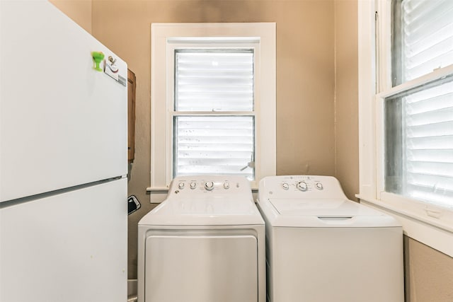 clothes washing area with washing machine and dryer