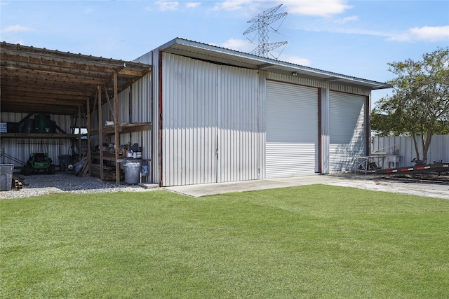 view of outdoor structure with a lawn and a garage