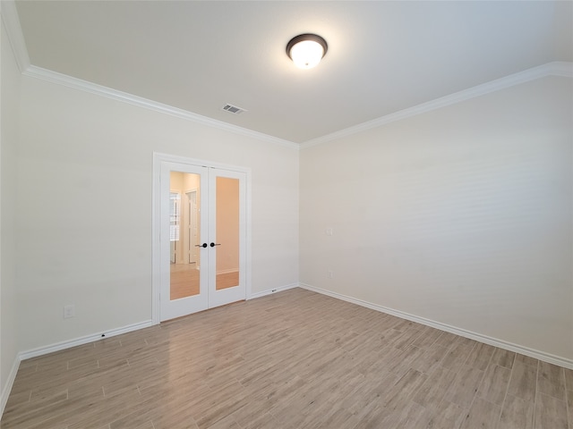 empty room featuring ornamental molding, light hardwood / wood-style flooring, and french doors