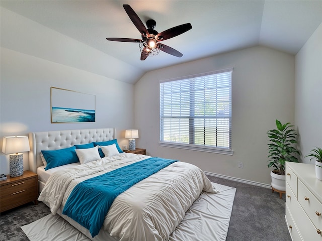 bedroom with dark colored carpet, vaulted ceiling, and ceiling fan