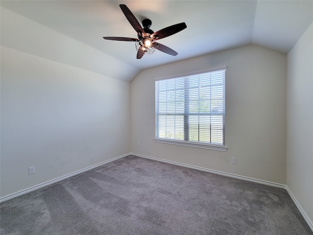 carpeted spare room featuring lofted ceiling and ceiling fan