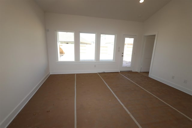 spare room featuring lofted ceiling