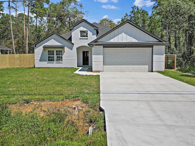 view of front of property with a front yard and a garage