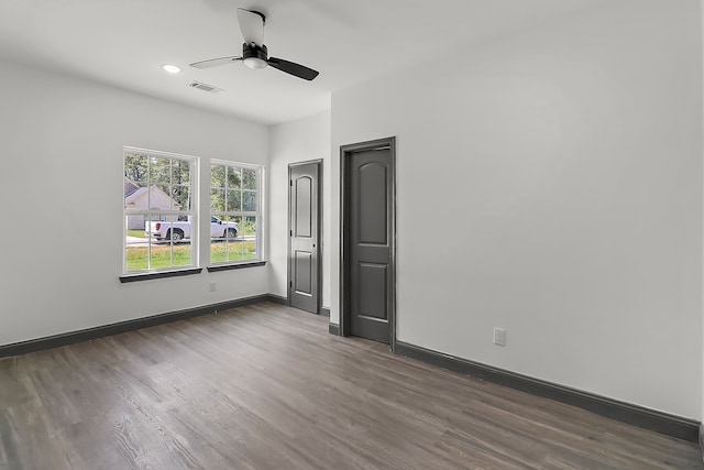 unfurnished bedroom with dark wood-type flooring and ceiling fan