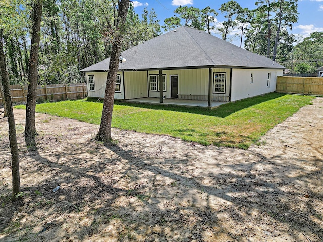 back of property featuring a yard