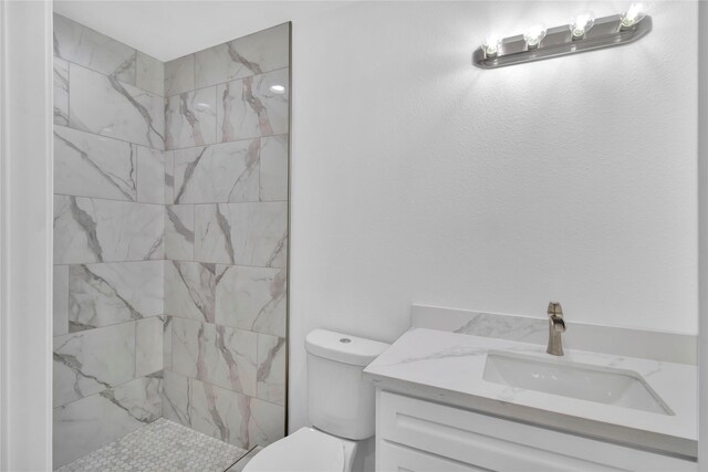 1307 Brooks Ave, Rosenberg, TX 77471 - bathroom with toilet, vanity, and tiled shower