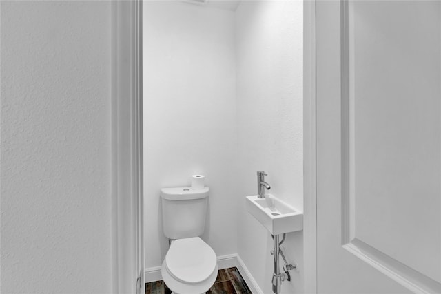 1307 Brooks Ave, Rosenberg, TX 77471 - half bath featuring toilet and wood finished floors
