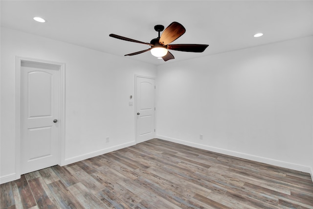 spare room featuring light hardwood / wood-style floors and ceiling fan