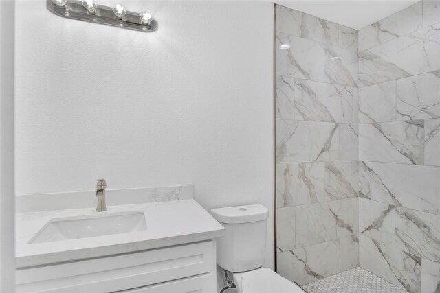 1307 Brooks Ave, Rosenberg, TX 77471 - bathroom with vanity, toilet, and a tile shower