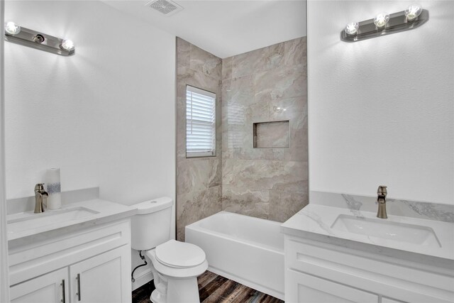 1307 Brooks Ave, Rosenberg, TX 77471 - full bath with vanity, toilet, wood finished floors, and shower / tub combination