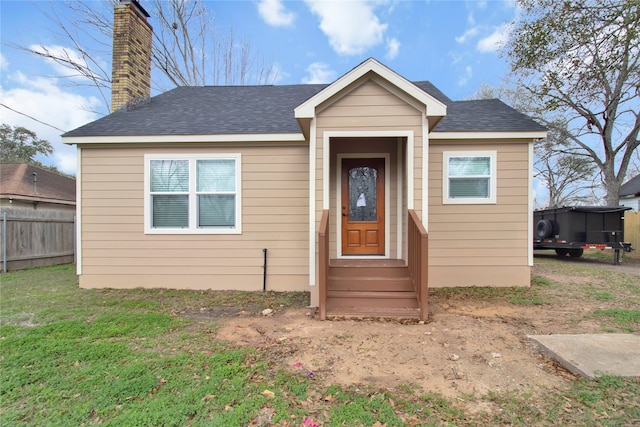 bungalow-style house with a front lawn