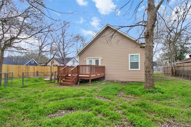 back of house with a deck and a yard