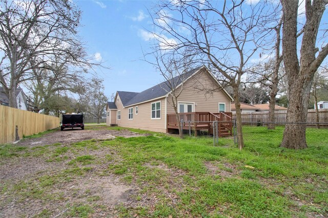 1307 Brooks Ave, Rosenberg, TX 77471 - rear view of property with a deck and driveway