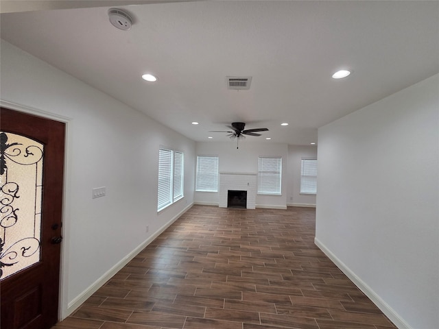 1307 Brooks Ave, Rosenberg, TX 77471 - unfurnished living room with a ceiling fan, baseboards, a brick fireplace, dark wood finished floors, and recessed lighting