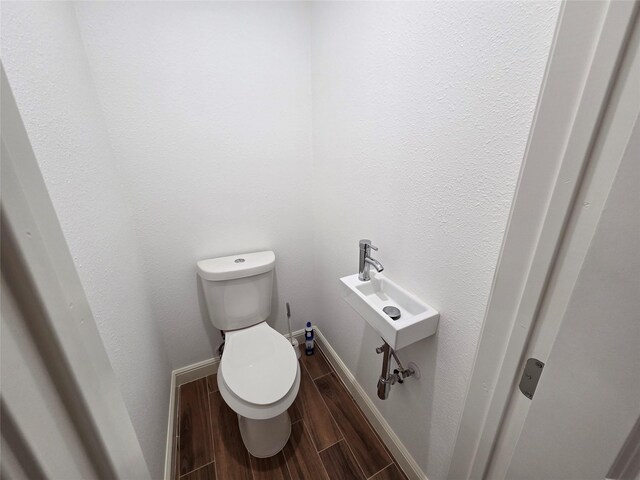 1307 Brooks Ave, Rosenberg, TX 77471 - bathroom with toilet, wood tiled floors, and baseboards