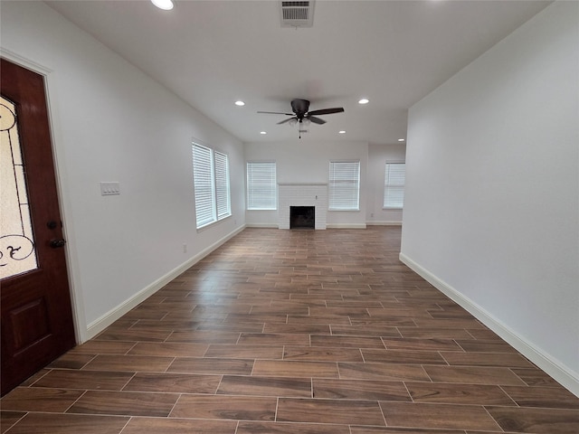 1307 Brooks Ave, Rosenberg, TX 77471 - unfurnished living room featuring ceiling fan, dark wood-style floors, recessed lighting, baseboards, and a fireplace