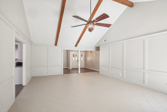 unfurnished room with beam ceiling, high vaulted ceiling, and ceiling fan