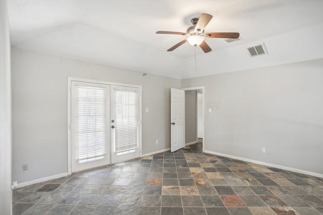 empty room featuring lofted ceiling, french doors, and ceiling fan