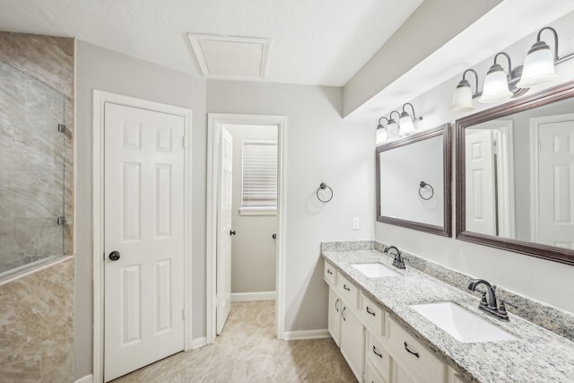 bathroom with vanity and a tile shower