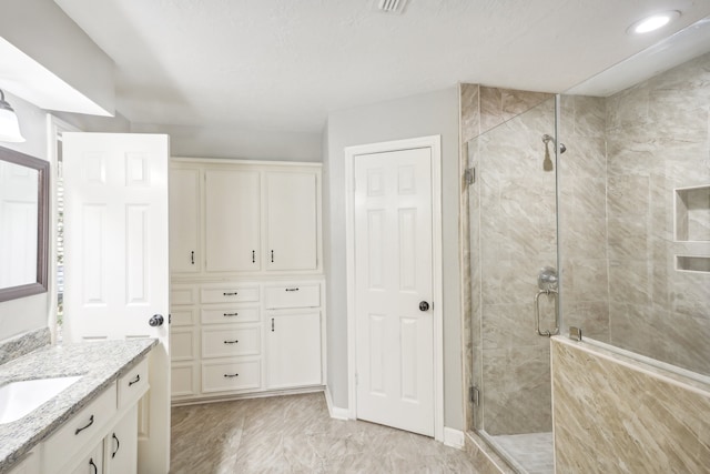 bathroom with vanity and a shower with shower door