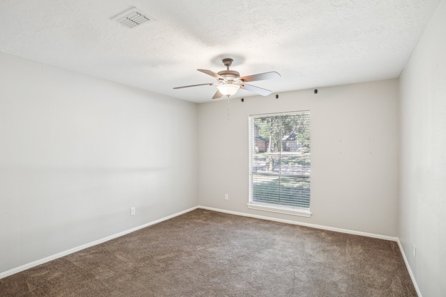 spare room with a textured ceiling, carpet, and ceiling fan