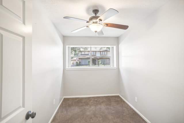 spare room featuring carpet flooring and ceiling fan