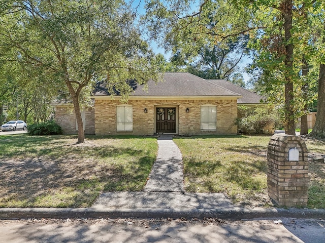 ranch-style home featuring a front yard