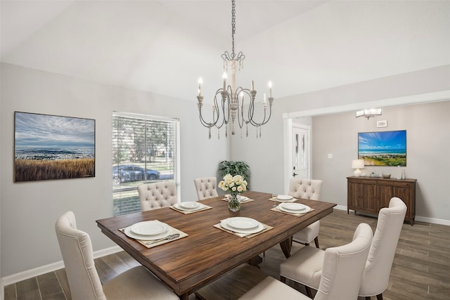 dining area with hardwood / wood-style floors, a chandelier, and vaulted ceiling