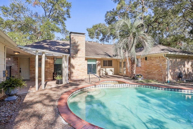 view of swimming pool with a patio