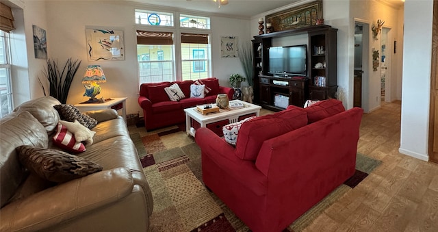 living room with hardwood / wood-style flooring and crown molding