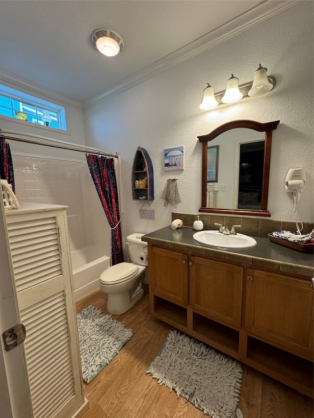 full bathroom with vanity, shower / bath combo, wood-type flooring, crown molding, and toilet