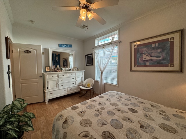 bedroom with ceiling fan, light hardwood / wood-style flooring, and ornamental molding