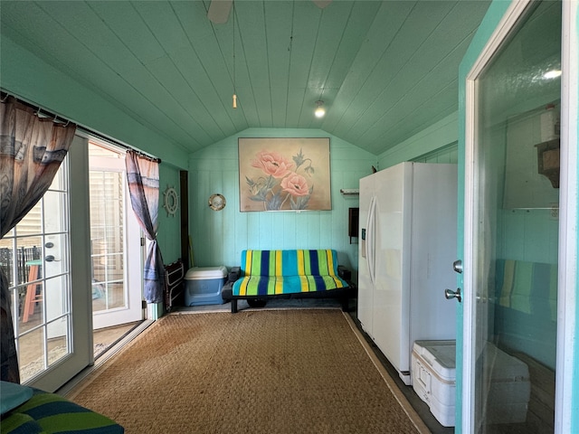 interior space featuring lofted ceiling, carpet, and a wealth of natural light