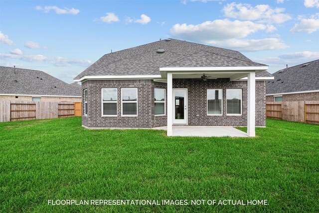 back of house featuring a lawn, ceiling fan, and a patio