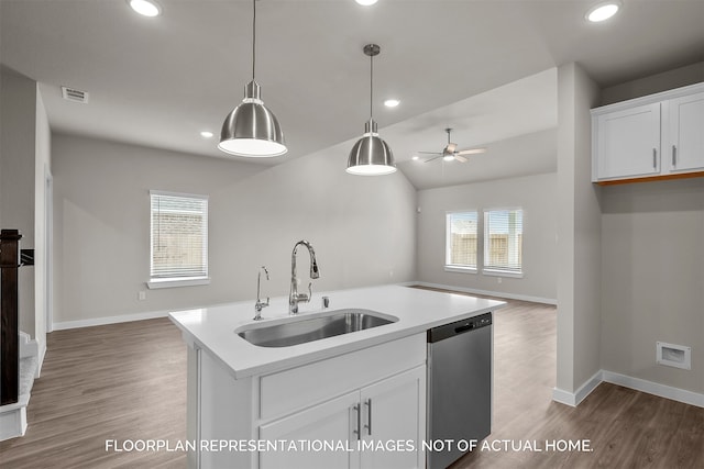 kitchen with a center island with sink, ceiling fan, stainless steel dishwasher, white cabinets, and sink