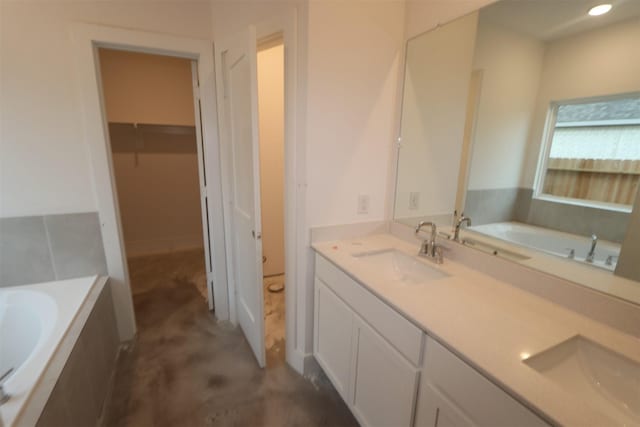 bathroom featuring a bath, vanity, and concrete flooring