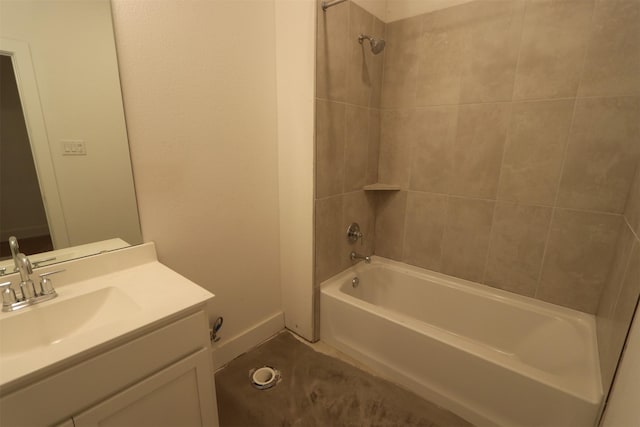 bathroom featuring tiled shower / bath combo and vanity