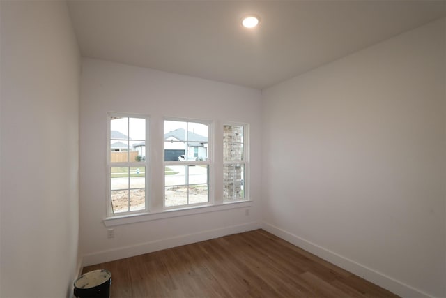 unfurnished room with dark wood-type flooring