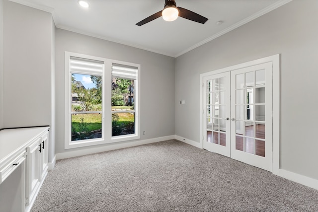 carpeted empty room with ceiling fan, french doors, and crown molding